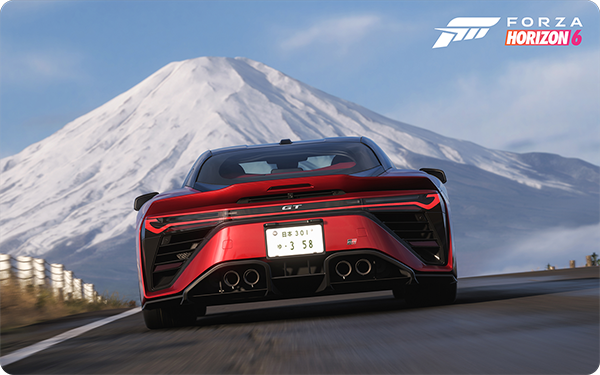 A red sports car driving towards a snow-capped mountain in a video game setting.